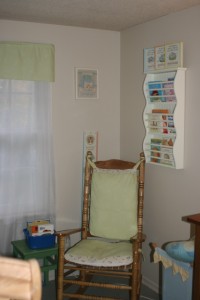 Rocking chair cushions, windown panel above sheers, and the awesome Pottry Barn book shelf.